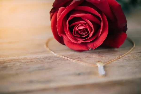 Red rose flower on wooden floor in Valentine's Day