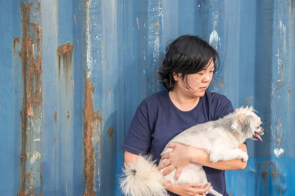 Asian woman and dog happy hugging with container