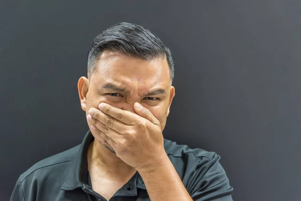 Asian man prevent stench on background dark style