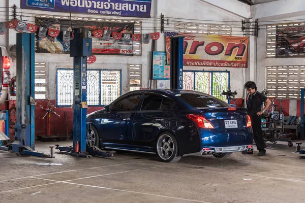 Checking a car suspension for repair at car garage — Stock Photo, Image