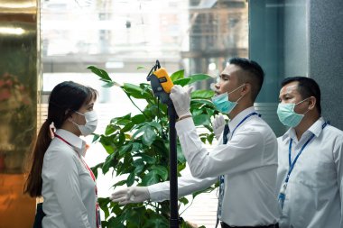 Bangkok, Thailand - March 16, 2020 : Unidentified people waiting body temperature check to access building for against epidemic flu covid19 or corona virus by thermoscan or infrared thermal camera