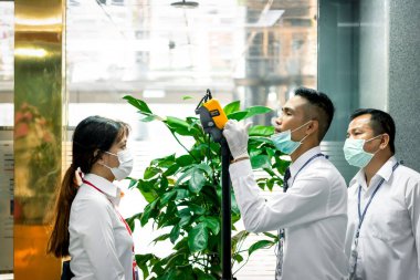 Bangkok, Thailand - March 16, 2020 : Unidentified people waiting body temperature check to access building for against epidemic flu covid19 or corona virus by thermoscan or infrared thermal camera