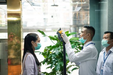 Bangkok, Thailand - March 16, 2020 : Unidentified people waiting body temperature check to access building for against epidemic flu covid19 or corona virus by thermoscan or infrared thermal camera