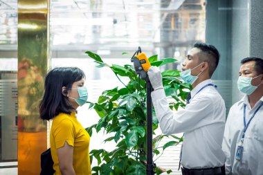 Bangkok, Thailand - March 16, 2020 : Unidentified people waiting body temperature check to access building for against epidemic flu covid19 or corona virus by thermoscan or infrared thermal camera