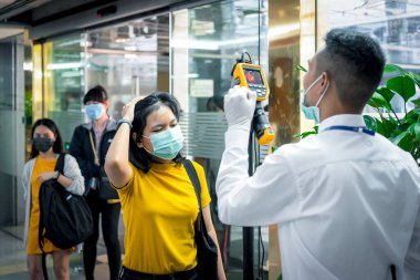 Bangkok, Thailand - March 16, 2020 : Unidentified people waiting body temperature check to access building for against epidemic flu covid19 or corona virus by thermoscan or infrared thermal camera
