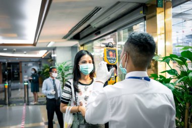 Bangkok, Thailand - March 16, 2020 : Unidentified people waiting body temperature check to access building for against epidemic flu covid19 or corona virus by thermoscan or infrared thermal camera
