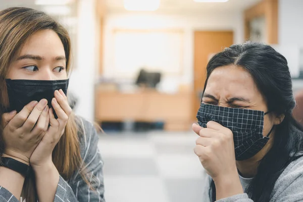 Asian pretty women wearing mask respiratory protection mask against epidemic flu covid19 or corona virus from wuhan in office with fear emotion in concept illness, outbreak, healthcare in life