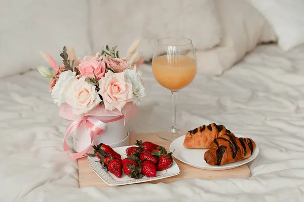 Breakfast in bed with a bouquet of flowers