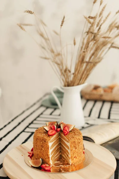 Honey cake. Cake with figs.  Honey confectionery. Bright interior in the kitchen