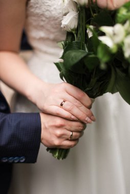 Gelin ve damat el ele tutuşuyor. Tarz sahibi damat ve gelin. Gelin ve damat için fotoğraf çekimi. Evlilik yüzükleri.. 