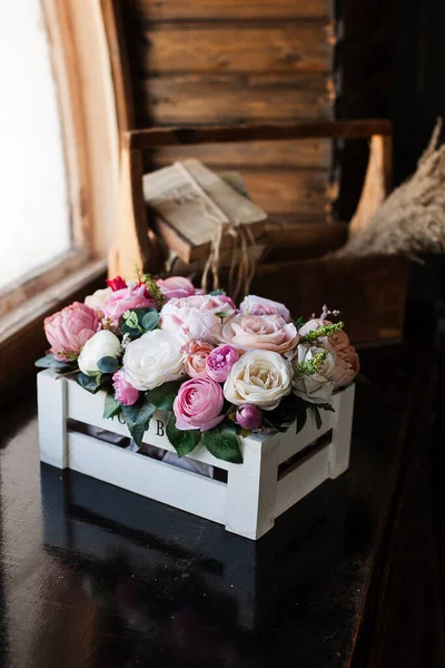 Artificial flowers. Decorative flowers as a gift. Flowers in a gift box.