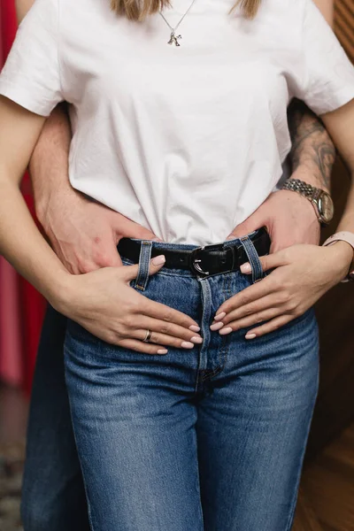 A man hugs a woman. A hug of the hand. A couple hugging.