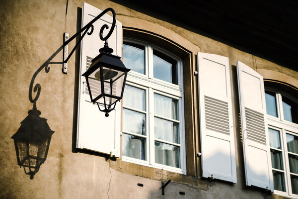 Beautiful shadows of street lamp on the house wall