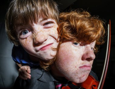 Emotive portrait of red-haired freckled boy, childhood concept clipart