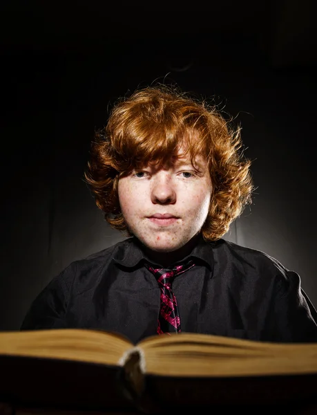 Freckled red-haired teenage boy reading book, education concept — Stock Photo, Image