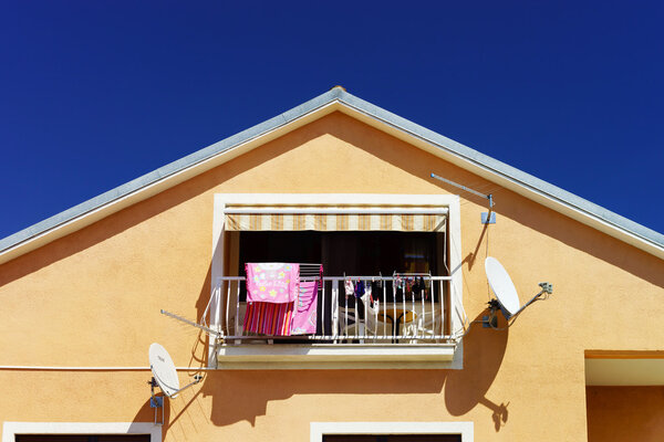 House with balcony on sea resort, sunny day, touristic concept.