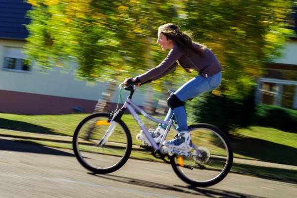 Chica adolescente en bicicleta en botas de rodillo. Disparo rápido — Foto de Stock