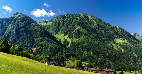 Beautiful alpine summer landscape. Mountains and sun, blue sky, 