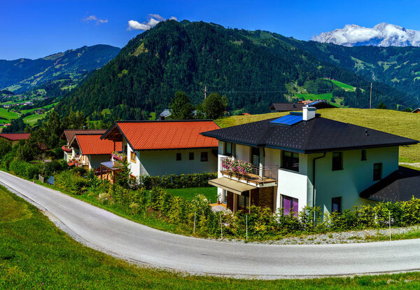 Beautiful alpine summer landscape. Mountains and sun, blue sky, calm place. Austria.