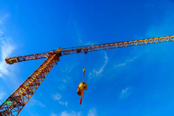Big crane over the city on blue sky background — Stock Photo, Image