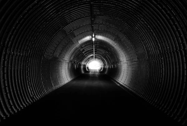 Long dark tunnel, circle form. Light at the end. — Stock Photo, Image