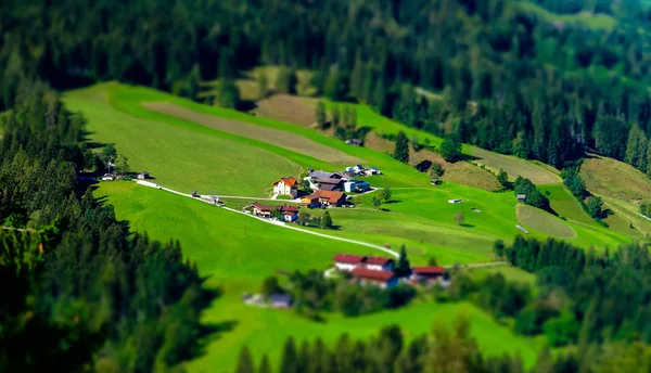 Tilt-shift aerial view of little austrian city in the valley — Stock Photo, Image