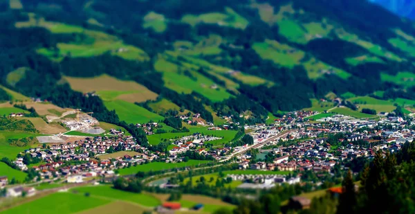 Tilt-shift aerial view of little austrian city in the valley