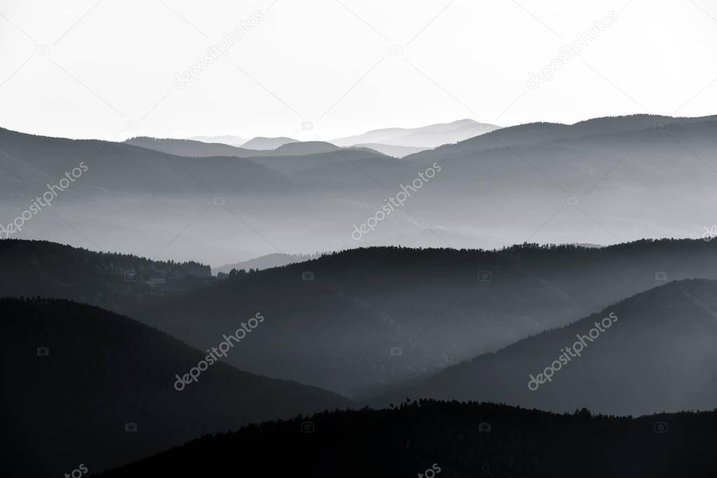 Aerial view of foggy mountains relief