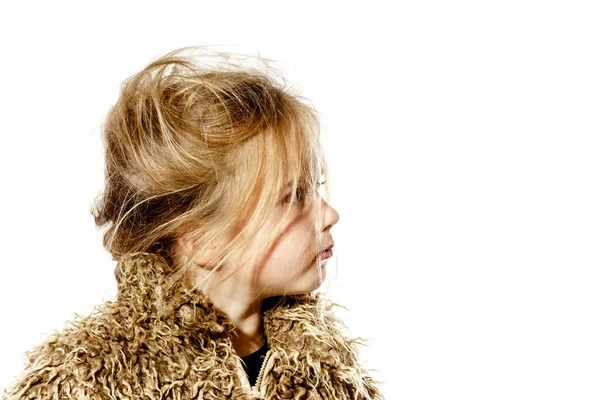 Disheveled preschooler girl with long hair dressed in fur coat — Stock Photo, Image