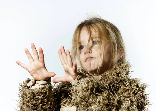 Disheveled preschooler girl with long hair dressed in fur coat — Stock Photo, Image