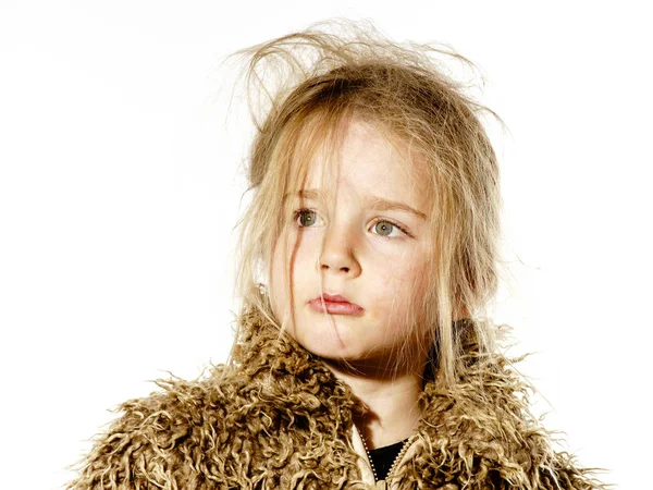 Disheveled preschooler girl with long hair dressed in fur coat — Stock Photo, Image