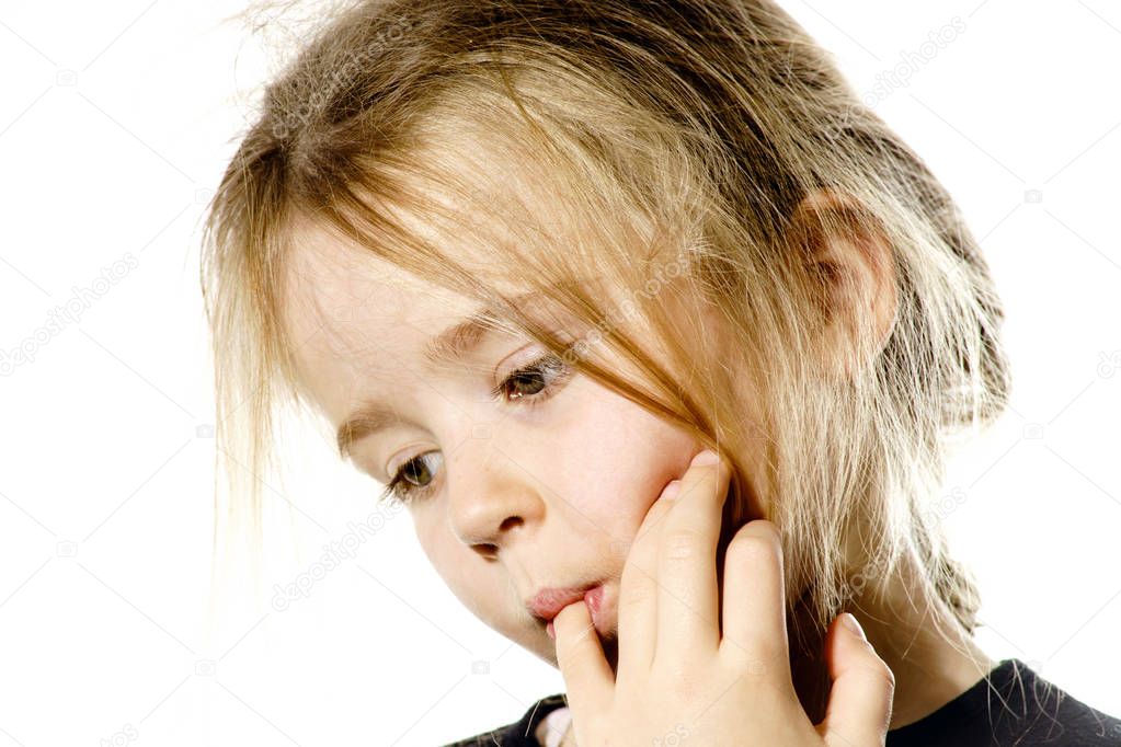 Disheveled preschooler girl with long hair thinking