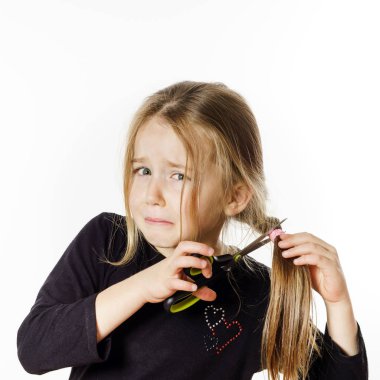 Cute little girl with scissors. Self hairdresser clipart