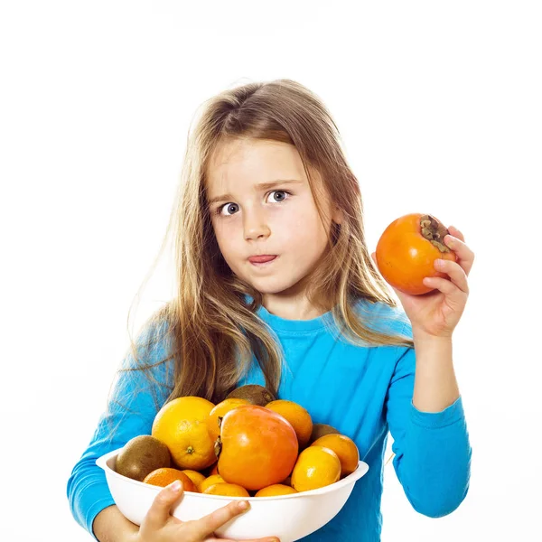 Söt liten flicka med tallrik frukt: kiwi, datum plommon, mandarin — Stockfoto