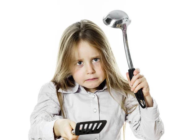 Angry little girl with soup ladle — Stock Photo, Image