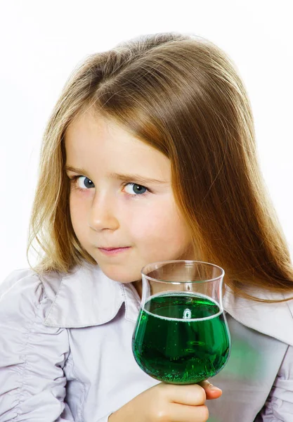 생생한 녹색 액체, 어쩌면 독의 유리를 가진 어린 소녀 — 스톡 사진