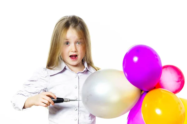 Funny little girl blowing up colorful baloons — Stock Photo, Image