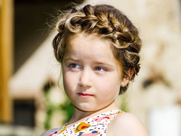 Cute little preschooler girl natural portrait on the sun