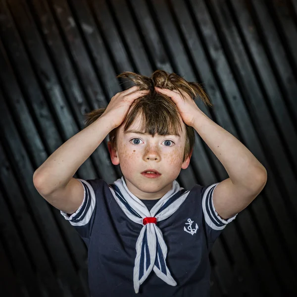 Schoolboy posing in sailor costume with emotions — Stock Photo, Image