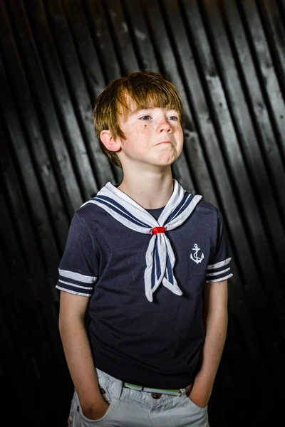 Schoolboy posing in sailor costume with emotions — Stock Photo, Image