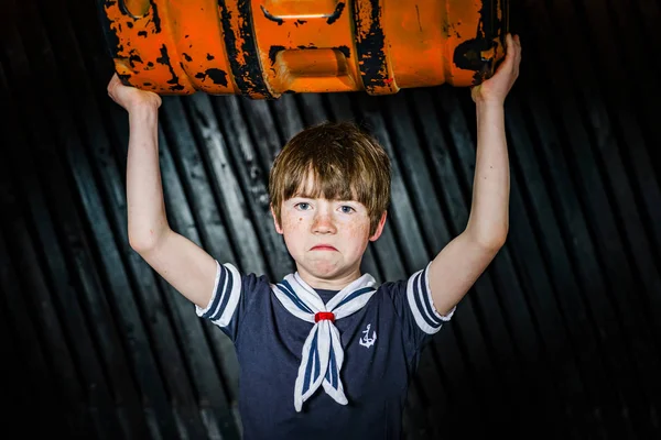 Schoolboy posing in sailor costume with emotions — Stock Photo, Image