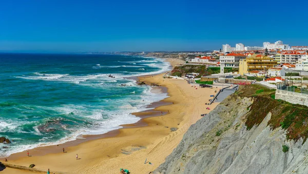 Yellow rocks and sand on portuguese coastline, vivid ocean water — Stock Photo, Image