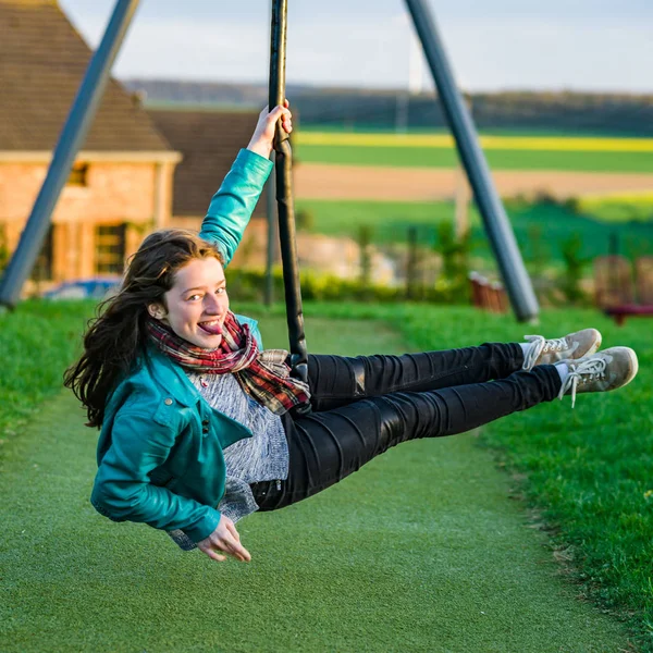 Teenage girl playing on children playground, evening — Stock Photo, Image