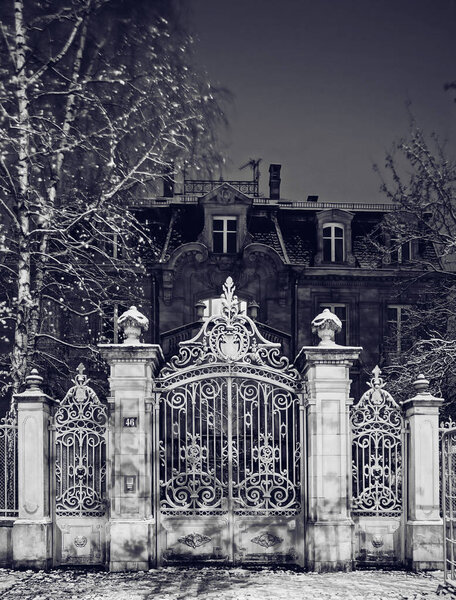 Majestic wrought iron lattice gates, night view, winter