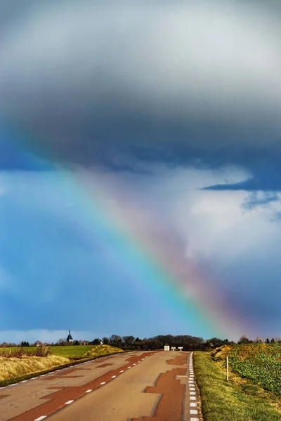 Schöner bunter Regenbogen am Ende der Asphaltstraße, Perspektiven — Stockfoto