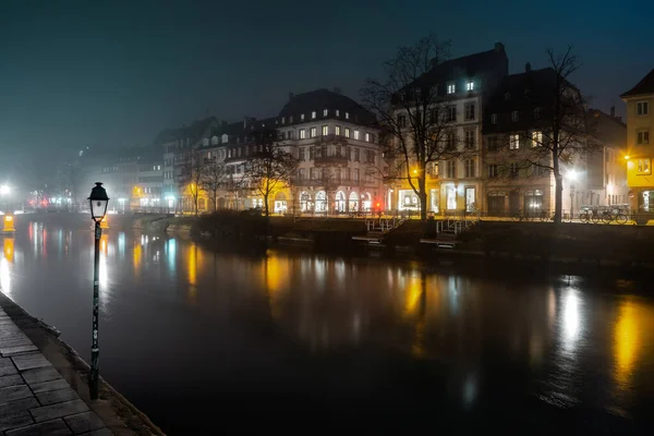 Ile River Embankment in Strasbourg at night, fog. Reflections of — Stockfoto