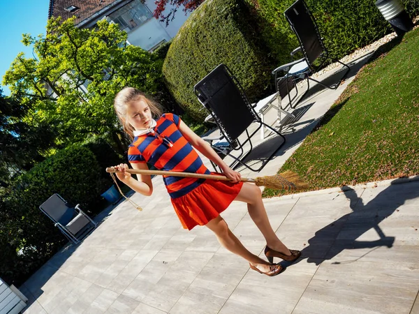 Een Schoolmeisje Poseert Met Een Bezem Haar Moeders Schoenen Tuin — Stockfoto