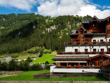 Yazın Avusturya 'da bir dağlık bölgenin yeşil tepeleri. Küçük bir köy, oteller ve Chalet 'ler, hepsi renkli. Çatılarda güzel teraslar ve güneş panelleri var. Medeniyetin yakınlığı ve saf doğa. Grossarl.
