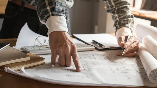 Creative architect projecting on the big drawings in the dark lo — Stock Photo, Image