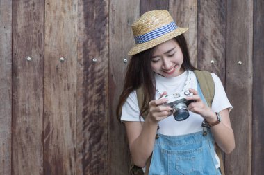 Young asian butiful woman with camera. in a blue shirt. Hipster  clipart